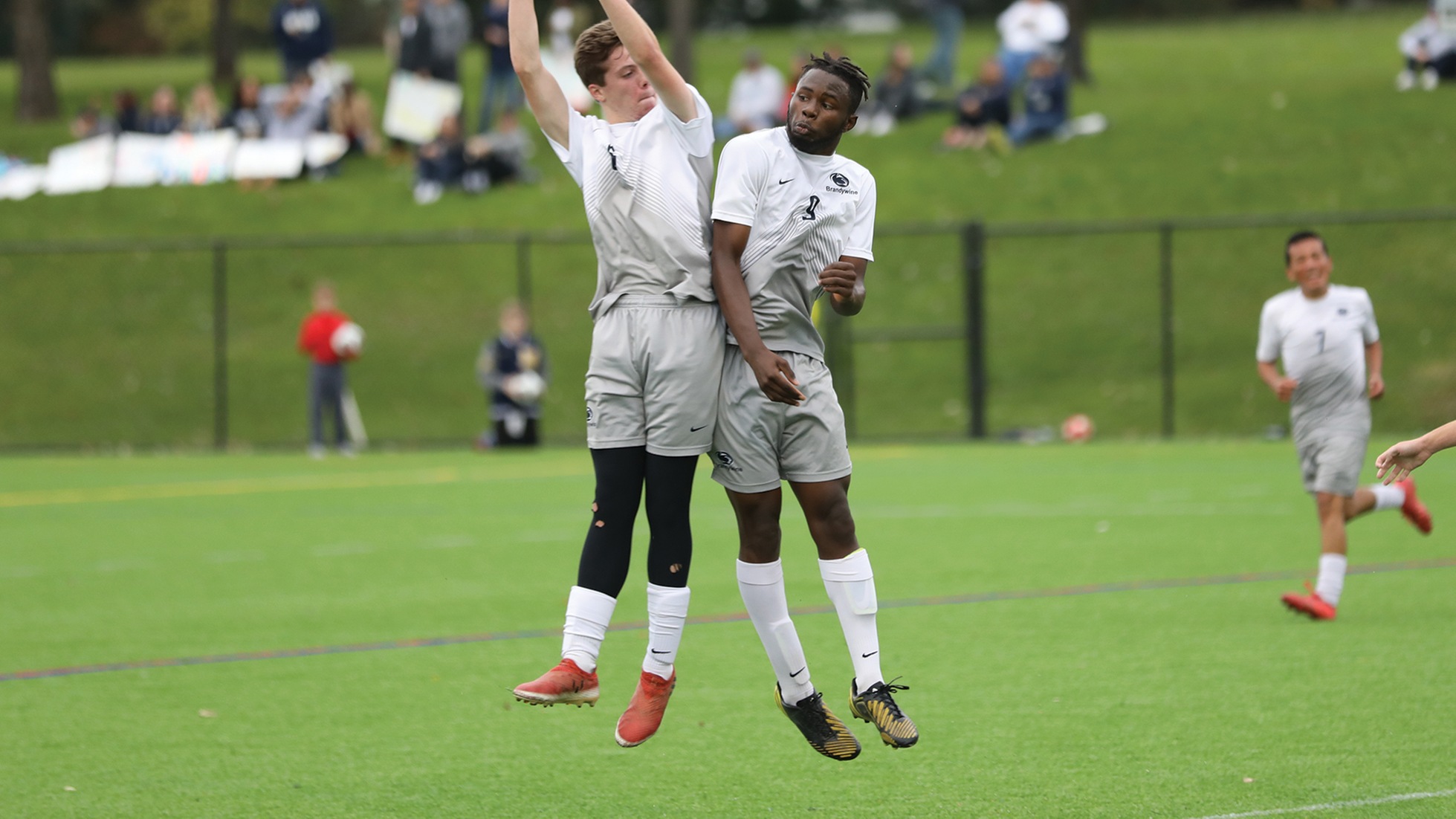 Ian Roland and Mohamed Camara celebrate a third-straight PSUAC soccer title