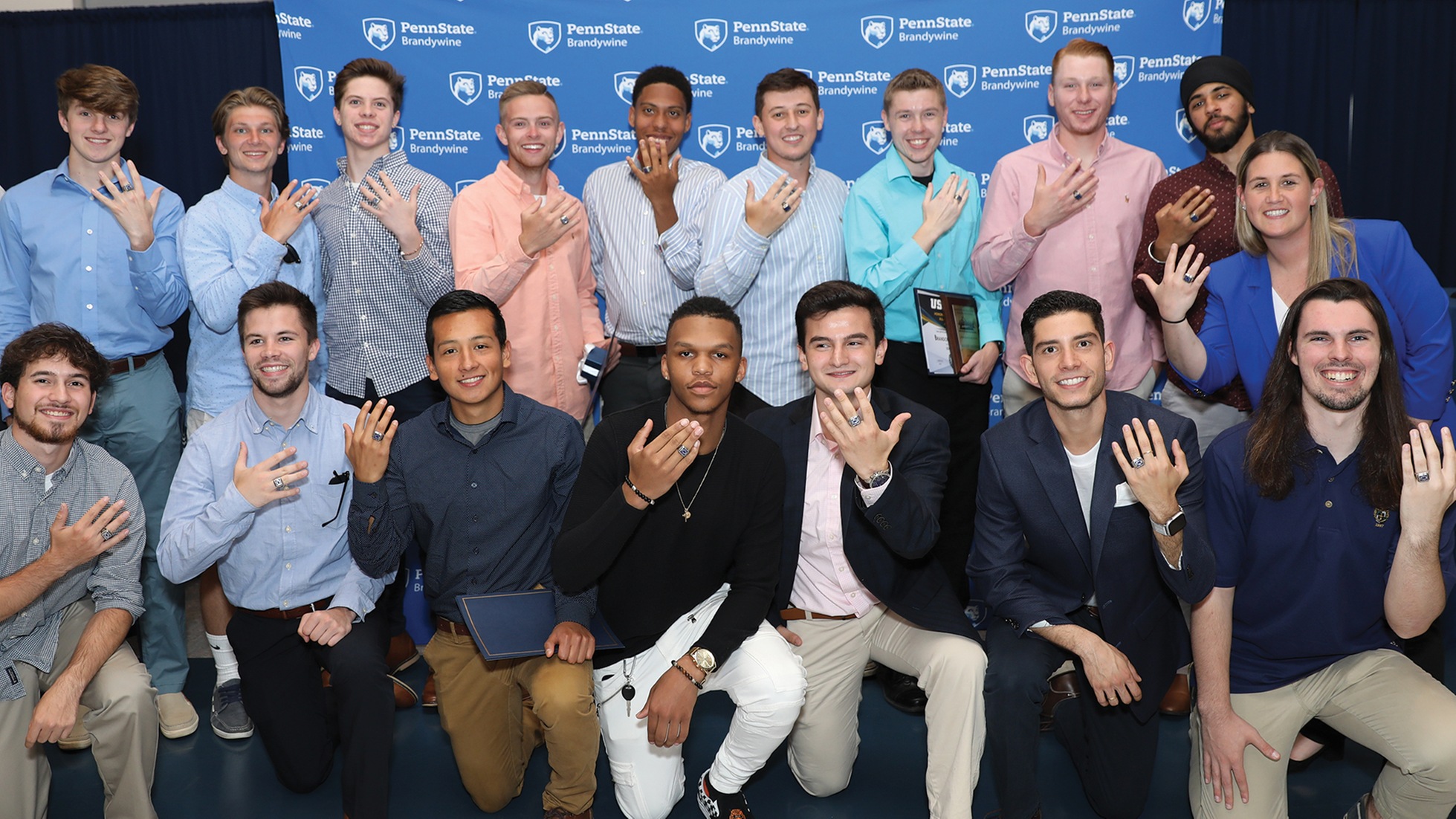 Members of the men's soccer team show off their national championship rings