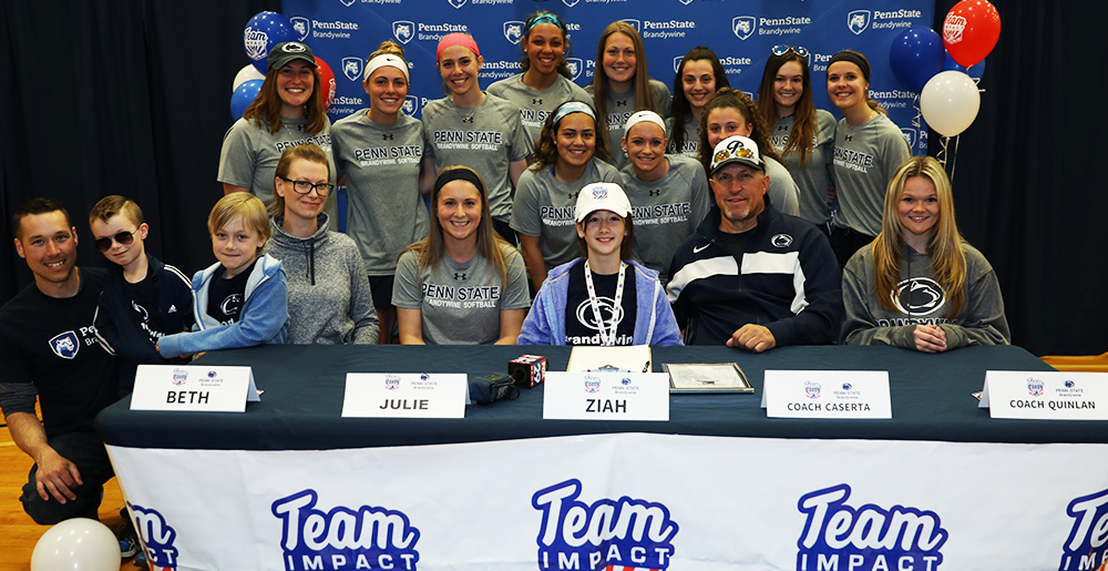 Ziah Oyler surrounded by her family, teammates and coaches on draft day