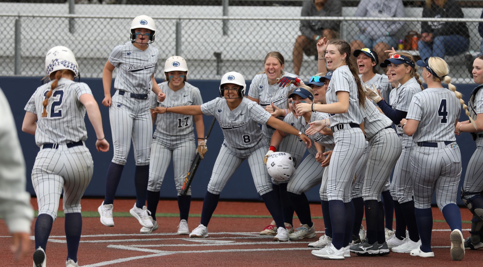 Teammates wait to celebrate Meghan Ferry's second home run of the day