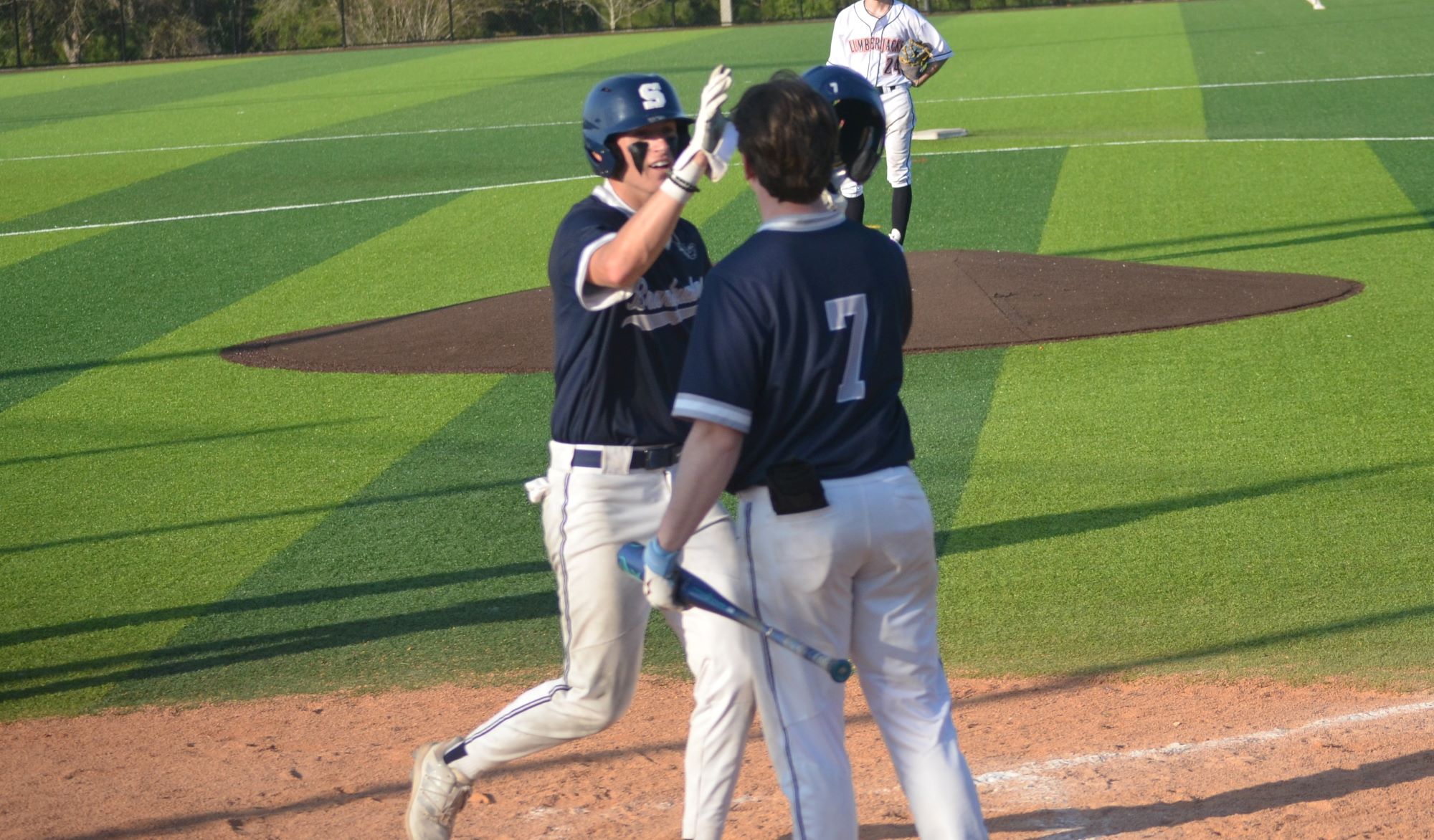 Cam Baughman celebrates his first of two home runs with Evan Abegg